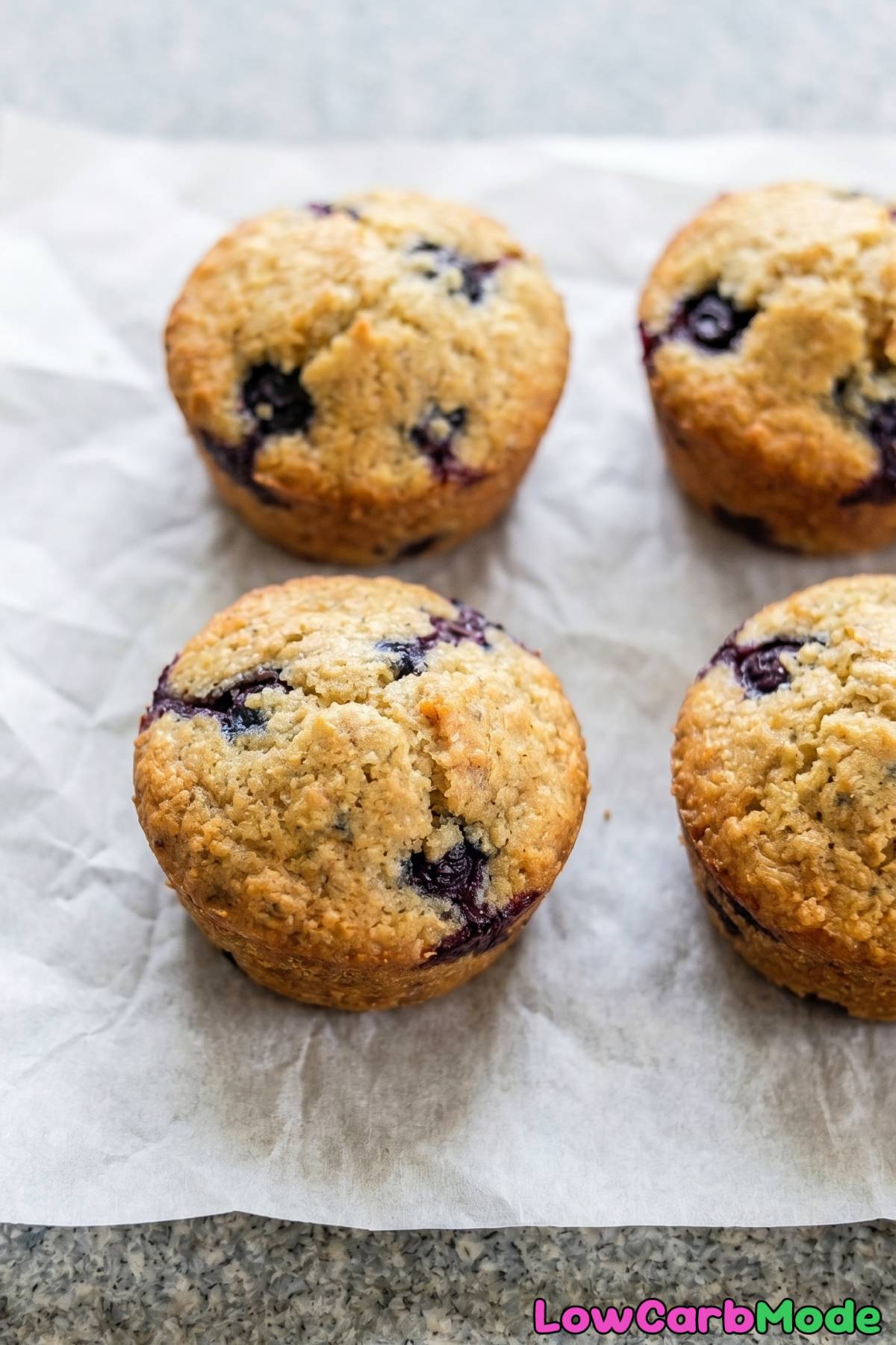 Moist keto blueberry muffins on a rack
