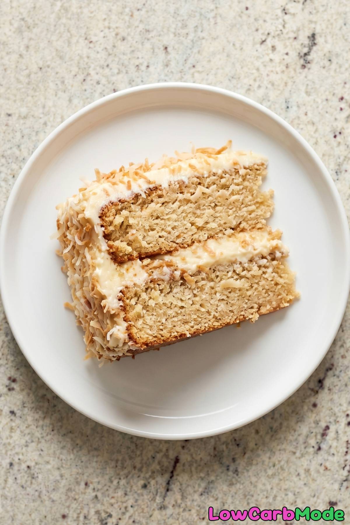 Soft keto coconut cake topped with flakes