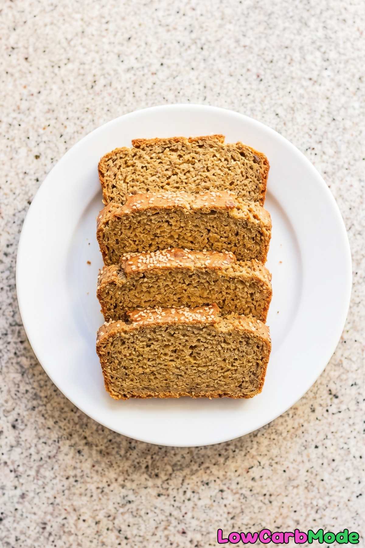 Warm keto flaxseed bread sliced on a board