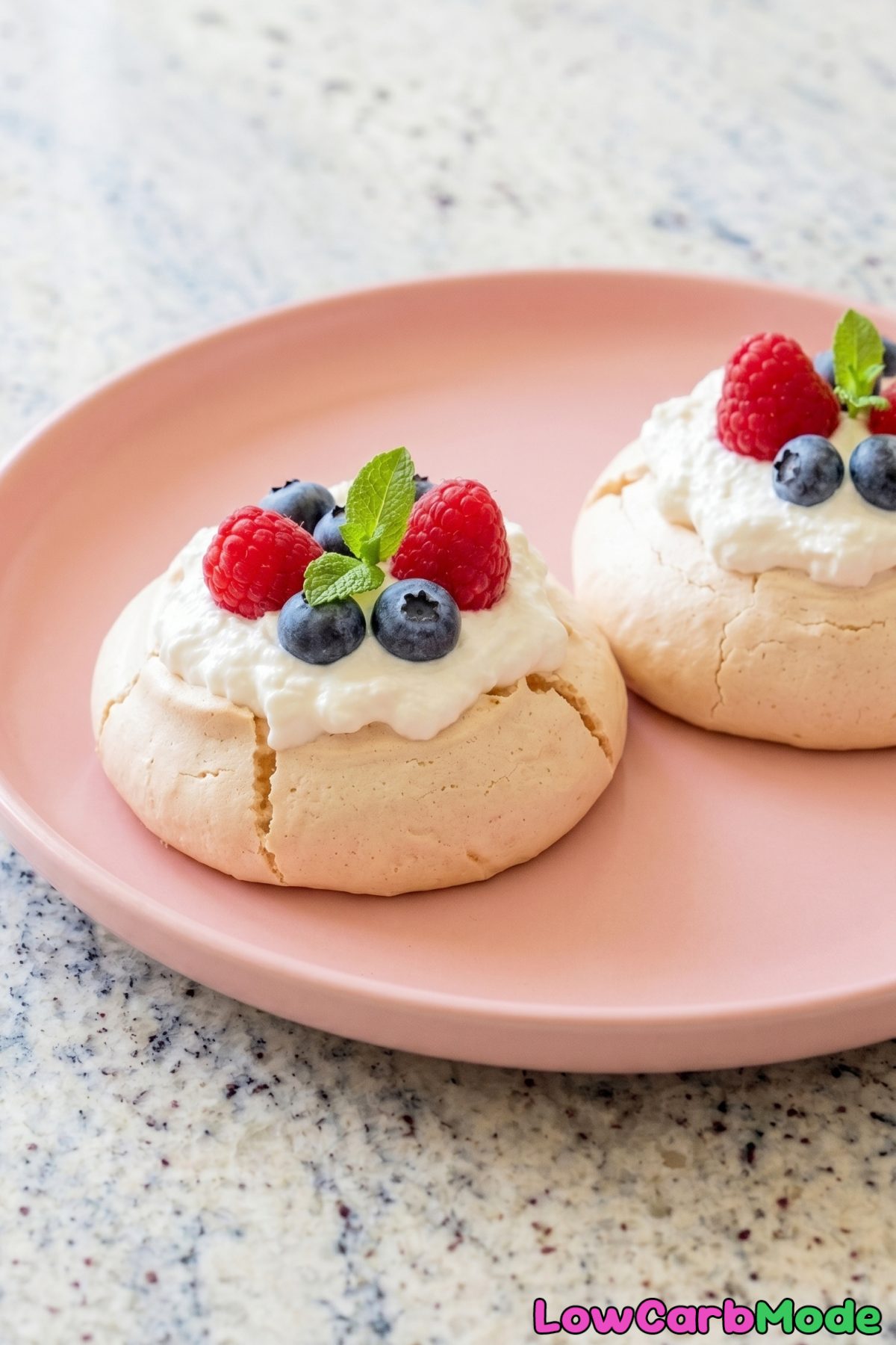 Delicate keto mini pavlovas topped with berries