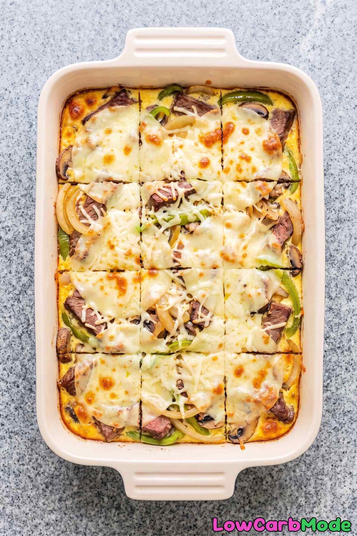 Melted cheese over keto cheesesteak casserole
