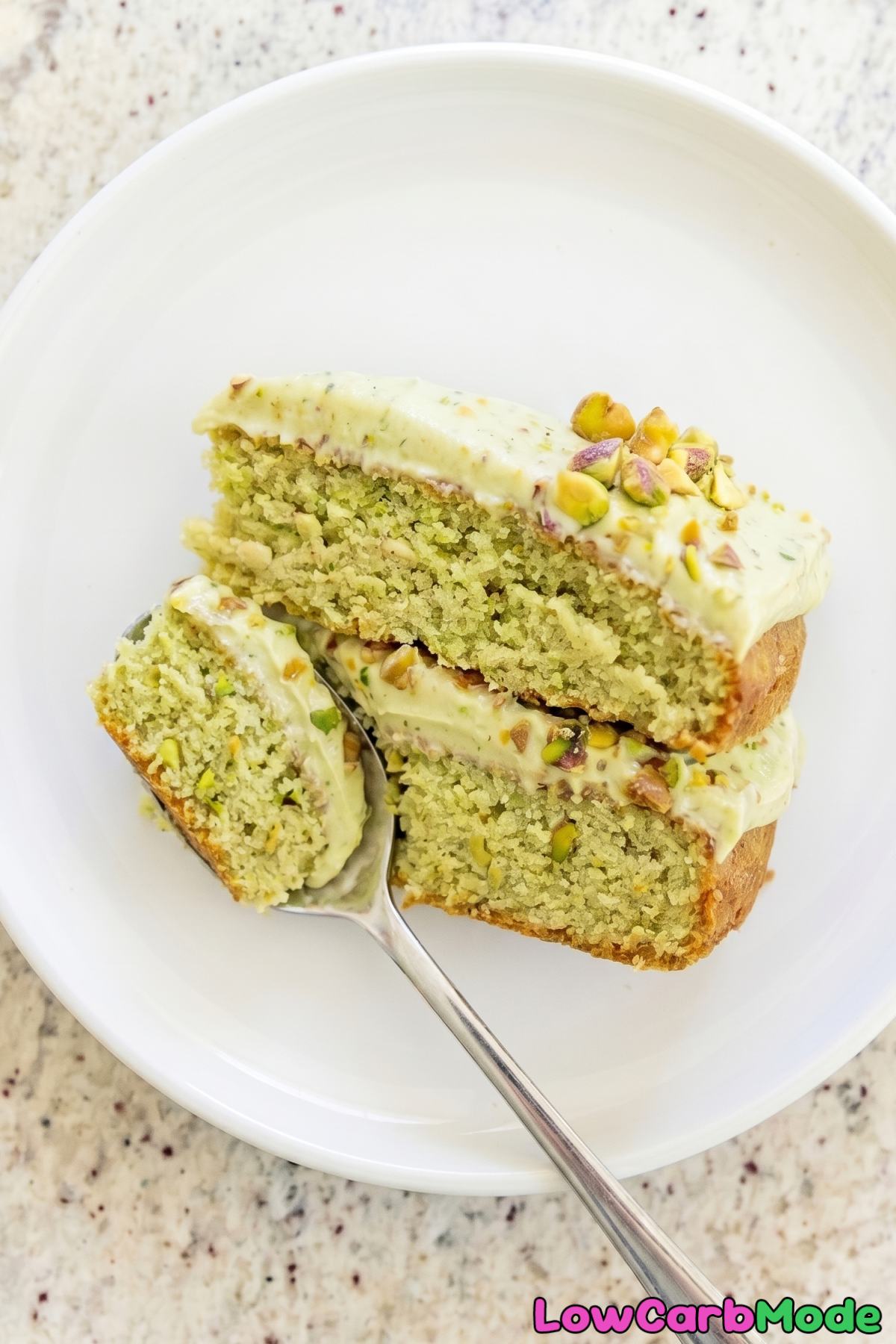 Rich keto pistachio cream cake on plate