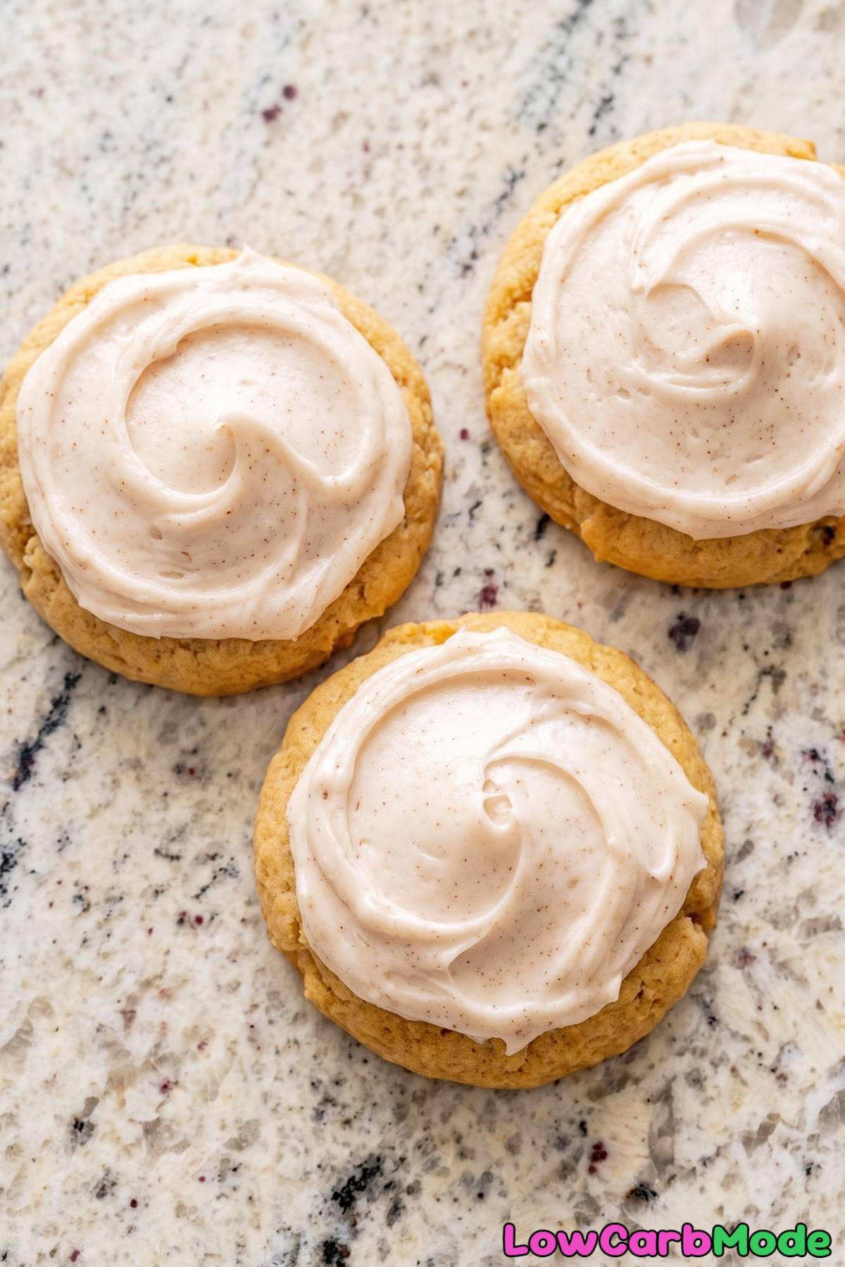Pumpkin keto cookies topped with white icing