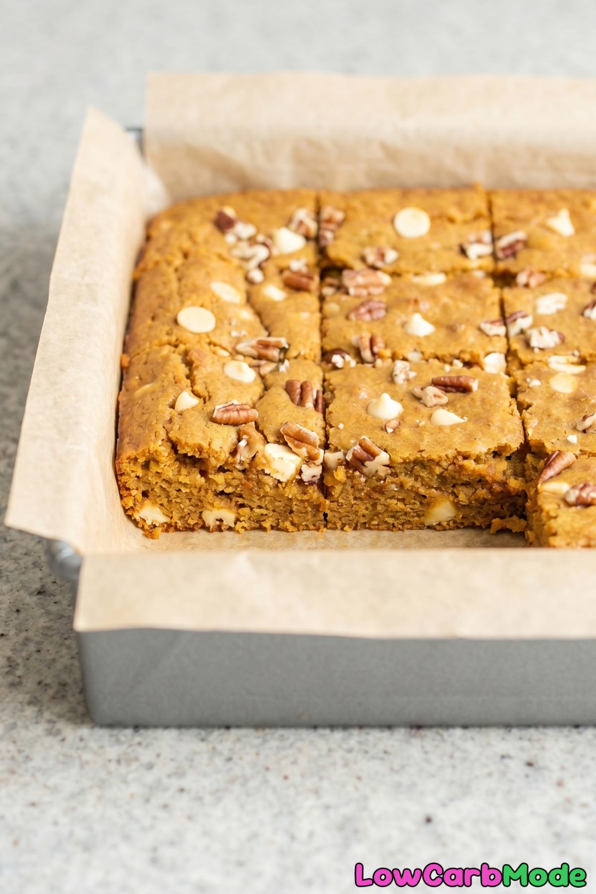 Spiced keto pumpkin blondies on a board