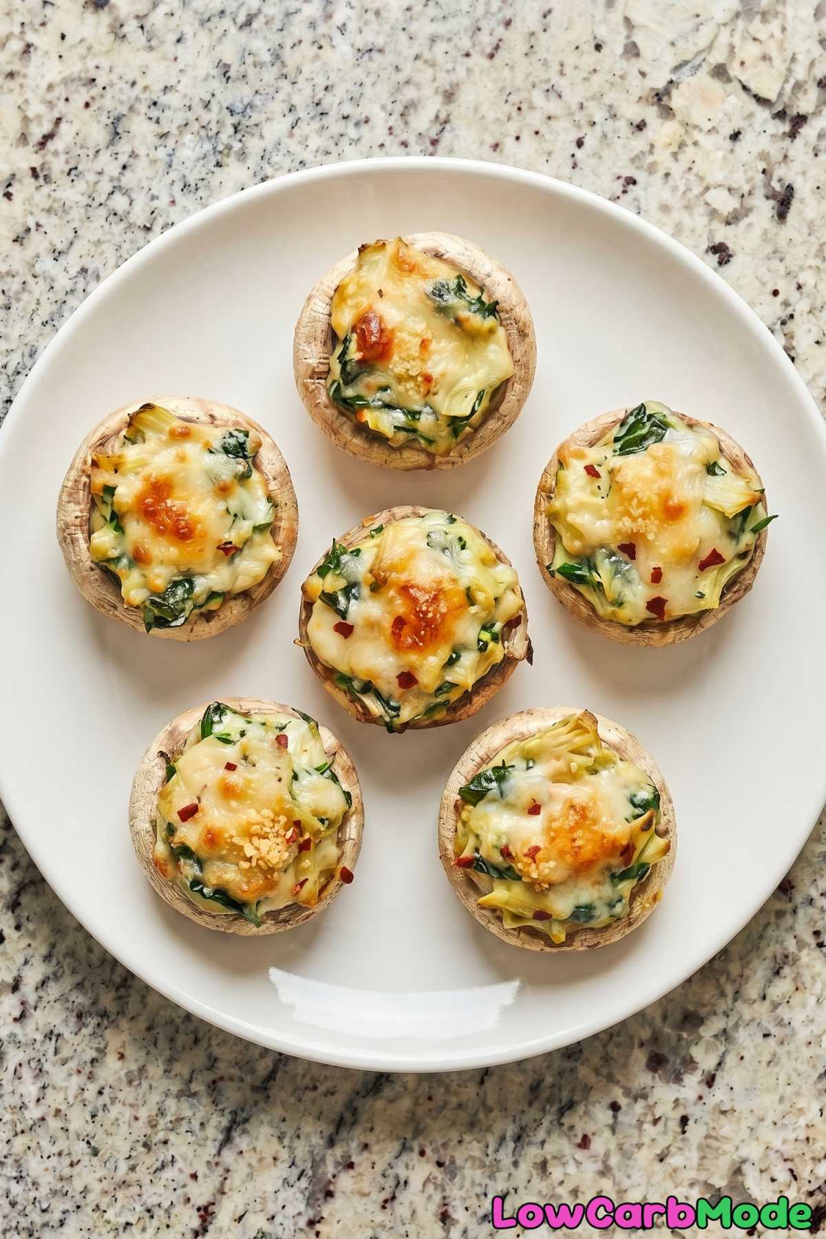 Golden keto spinach artichoke stuffed mushrooms